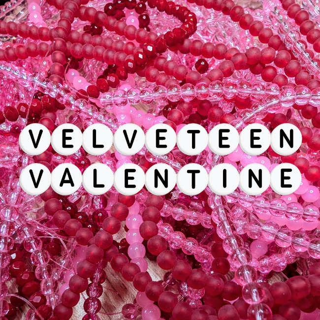A bold mix of red and pink elastic beaded bracelets made from glossy and frosted glass beads, with letter beads spelling “Velveteen Valentine ” A whimsical and romantic handmade jewellery collection full of dopamine jewellery and colourful accessories, crafted for quirky jewellery lovers.