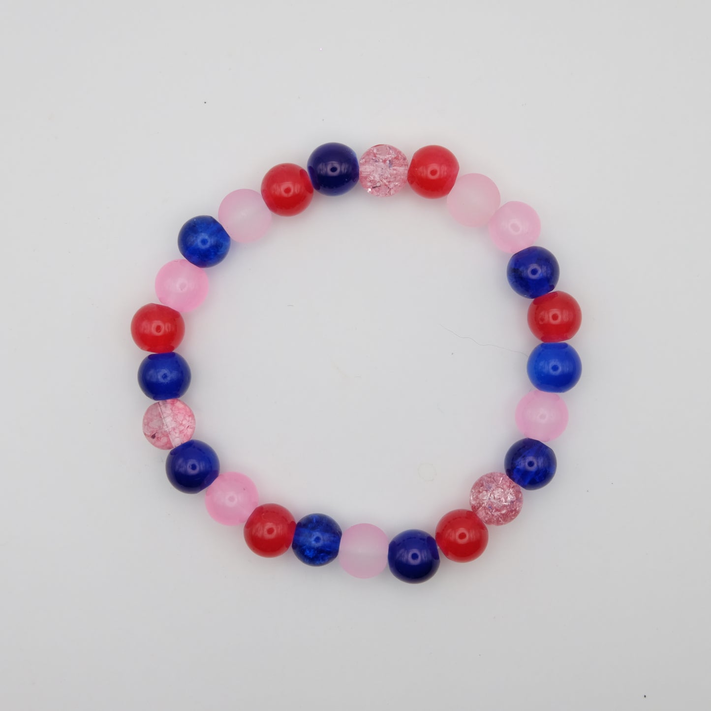 Beaded bracelet with red, blue, and pink beads on a white background