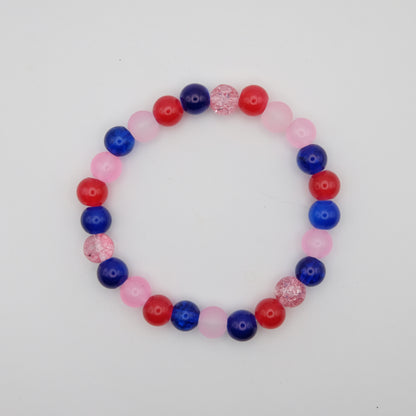 Beaded bracelet with red, blue, and pink beads on a white background