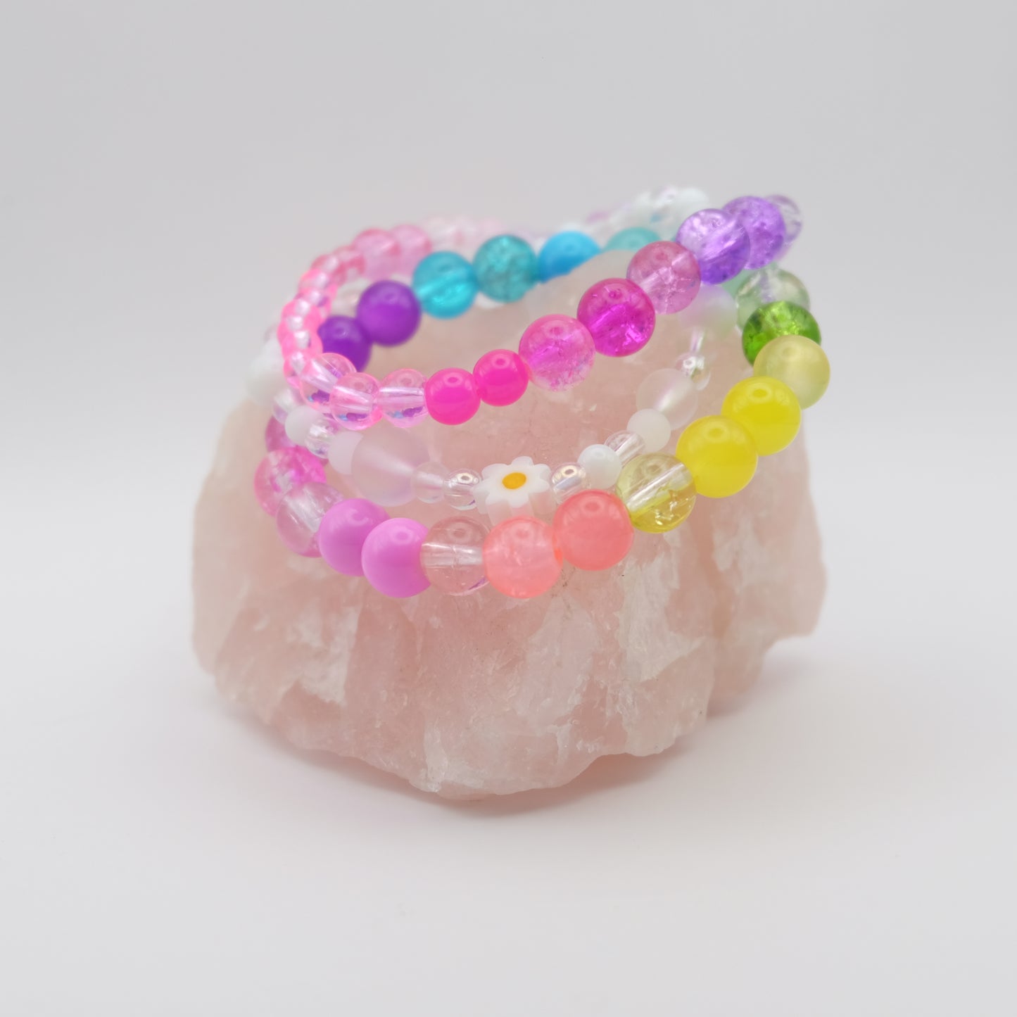 Handmade beaded bracelet stack with colourful glass beads and daisy accent, elastic jewellery crafted on the Gold Coast.